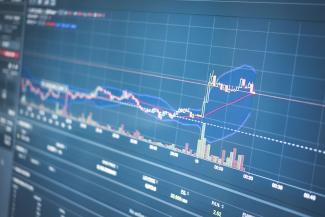 Close-up of a financial graph on a screen showing stock market trading data and trends.
