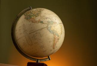 Elegant vintage globe showcasing world geography with a warm ambient background.