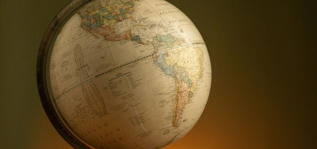 Elegant vintage globe showcasing world geography with a warm ambient background.