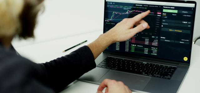 Person Using Black Laptop Computer With Financial Data